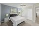 King-size bed, ceiling fan, and large window at 8831 Interlocking Ct, Davenport, FL 33896