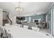 Open concept dining room with large table and chandelier at 8831 Interlocking Ct, Davenport, FL 33896