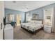 Main bedroom with king bed, TV, and access to bathroom at 8831 Interlocking Ct, Davenport, FL 33896