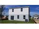 Exterior back of house featuring sliding glass doors that lead to green backyard at 5583 Maddie Dr, Haines City, FL 33845