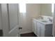 Bathroom featuring double sinks with chrome faucets and white cabinets beneath a large mirror at 5583 Maddie Dr, Haines City, FL 33845
