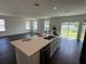 Open floor plan featuring a kitchen island with stainless steel sink and bar seating at 5583 Maddie Dr, Haines City, FL 33845