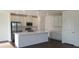Modern kitchen with stainless steel appliances, a large island, and white cabinets at 5583 Maddie Dr, Haines City, FL 33845