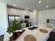 Bright, open kitchen with stainless steel appliances, white cabinets, and large island at 5583 Maddie Dr, Haines City, FL 33845