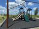 Community playground equipment including two slides, climbing wall, stairs, and a swing set at 5583 Maddie Dr, Haines City, FL 33845