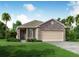 One-story home with stone accents and a two-car garage at 5599 Maddie Dr, Haines City, FL 33845