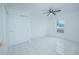 Bright bedroom with tile floors, double closet, and ceiling fan at 1048 Plantation Dr # E-9, Kissimmee, FL 34741