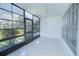 Spacious screened porch with tiled floor and ceiling fan at 1048 Plantation Dr # E-9, Kissimmee, FL 34741