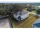 Aerial view of two-story house with backyard and surrounding neighborhood at 124 Lake Dr, Oviedo, FL 32765