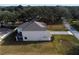 Aerial view of two-story house with backyard and paved driveway at 124 Lake Dr, Oviedo, FL 32765