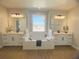 Spa-like bathroom with double vanities, a large soaking tub, and a window at 124 Lake Dr, Oviedo, FL 32765