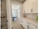 Butlers pantry with white cabinets, quartz countertops, and ample shelving at 124 Lake Dr, Oviedo, FL 32765