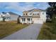 Two-story home with gray and beige exterior, paver driveway, and landscaping at 124 Lake Dr, Oviedo, FL 32765