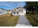 Two-story home with a gray roof and paver driveway, new construction at 124 Lake Dr, Oviedo, FL 32765