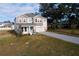 Two-story home with neutral siding, gray paver driveway and landscaping at 124 Lake Dr, Oviedo, FL 32765