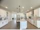 Modern white kitchen with an island, stainless steel appliances, and light wood floors at 124 Lake Dr, Oviedo, FL 32765