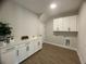 Bright laundry room with white cabinets and a countertop at 124 Lake Dr, Oviedo, FL 32765