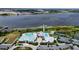 Stunning aerial view of the community pool, lake, pier and tennis courts at 4904 W Fountainwood Dr, St Cloud, FL 34772