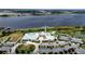 Beautiful aerial view featuring a pool, tennis courts, pier, and parking at 4904 W Fountainwood Dr, St Cloud, FL 34772