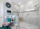 Shower room featuring glass door, neutral tiling, and light blue walls at 4904 W Fountainwood Dr, St Cloud, FL 34772