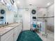 Bathroom with double sinks, granite counters, and a glass-enclosed shower at 4904 W Fountainwood Dr, St Cloud, FL 34772