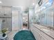 Bathroom with double vanity sinks, stylish decor, walk-in shower, and blue accent wall at 4904 W Fountainwood Dr, St Cloud, FL 34772