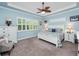 Spacious bedroom featuring neutral-colored carpet, white furnishings, and overhead fan at 4904 W Fountainwood Dr, St Cloud, FL 34772