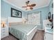 Blue bedroom featuring neutral-colored carpet, white furnishings, and overhead fan at 4904 W Fountainwood Dr, St Cloud, FL 34772