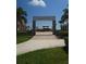 Attractive Emerson Plaza entrance, lined with palm trees, leading to the community amenities at 4904 W Fountainwood Dr, St Cloud, FL 34772