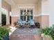 Inviting covered front porch with swivel chairs, decorative rug, and plants at 4904 W Fountainwood Dr, St Cloud, FL 34772