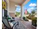 Relaxing covered porch with stylish chairs and views of the landscaped front yard at 4904 W Fountainwood Dr, St Cloud, FL 34772