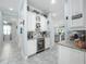 Hallway wet bar with white cabinetry, tile backsplash, and wine fridge at 4904 W Fountainwood Dr, St Cloud, FL 34772