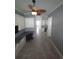 Hallway with built-in desk, white cabinets, and tile floors leads to kitchen at 4904 W Fountainwood Dr, St Cloud, FL 34772