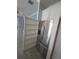 Modern kitchen with hidden storage shelves in pantry and stainless-steel refrigerator at 4904 W Fountainwood Dr, St Cloud, FL 34772