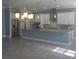 Open kitchen with a large center island, stainless appliances, and tile flooring at 4904 W Fountainwood Dr, St Cloud, FL 34772