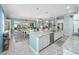 Open kitchen with island, stainless steel appliances, and a view of the living and dining areas at 4904 W Fountainwood Dr, St Cloud, FL 34772