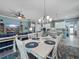Comfortable living room and dining area with white wood table and a view to the kitchen at 4904 W Fountainwood Dr, St Cloud, FL 34772