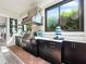 Covered outdoor kitchen featuring stainless steel grill, sink, cabinets, and tiled countertop at 4904 W Fountainwood Dr, St Cloud, FL 34772