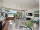 Screened in patio features outdoor seating, hot tub, grill, and ceiling fan at 4904 W Fountainwood Dr, St Cloud, FL 34772