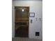 Indoor sauna with wooden benches, temperature controls, and a glass door at 4904 W Fountainwood Dr, St Cloud, FL 34772
