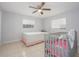 Bedroom with crib and ceiling fan at 1708 Nebraska Ave, Kissimmee, FL 34744