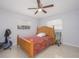 Bright bedroom with wood bed frame and ceiling fan at 1708 Nebraska Ave, Kissimmee, FL 34744