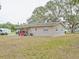 Tan block home with backyard at 1708 Nebraska Ave, Kissimmee, FL 34744