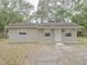 Tan block home with front yard at 1708 Nebraska Ave, Kissimmee, FL 34744