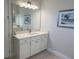 Modern bathroom featuring a large mirror, vanity, and bright light fixtures at 3962 Kennebunk Loop, Mount Dora, FL 32757