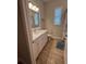Compact bathroom featuring a white vanity, modern fixtures, and natural light from a window at 3962 Kennebunk Loop, Mount Dora, FL 32757