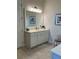 Bright bathroom with white vanity, large mirror, and contemporary fixtures offering a clean aesthetic at 3962 Kennebunk Loop, Mount Dora, FL 32757