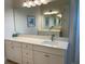 Bright bathroom featuring a large mirror, vanity, and ample counter space at 3962 Kennebunk Loop, Mount Dora, FL 32757