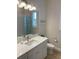 Well-lit bathroom with a vanity, sink, toilet, and shower with a curtain at 3962 Kennebunk Loop, Mount Dora, FL 32757