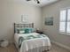Comfortable bedroom with a queen-sized bed, bright window, and cozy decor at 3962 Kennebunk Loop, Mount Dora, FL 32757